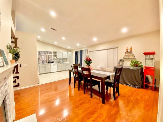 980 Lexington St, Hemet, CA 92545 - dining area with vaulted ceiling, recessed lighting, light wood-style flooring, and a fireplace