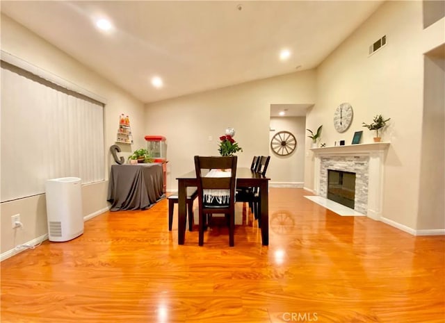 980 Lexington St, Hemet, CA 92545 - dining area with light wood-type flooring, vaulted ceiling, a fireplace, and recessed lighting