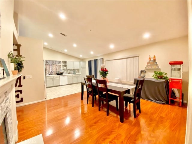 980 Lexington St, Hemet, CA 92545 - dining room featuring vaulted ceiling, recessed lighting, a fireplace, and light wood-type flooring