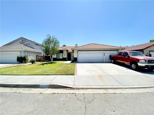 980 Lexington St, Hemet, CA 92545 - ranch-style house featuring a garage, a tile roof, concrete driveway, a chimney, and a front yard