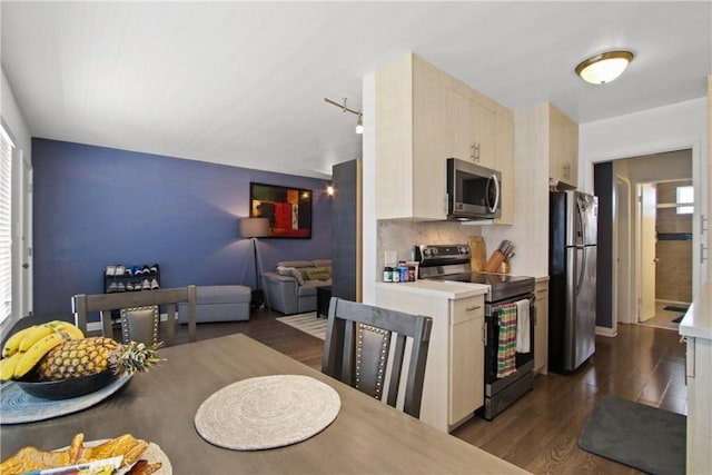 527 Cedar Ave Unit 2K, Long Beach, CA 90802 - kitchen with appliances with stainless steel finishes, dark wood-style floors, light countertops, light brown cabinetry, and open floor plan