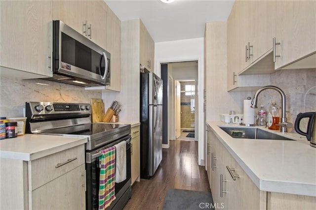 527 Cedar Ave Unit 2K, Long Beach, CA 90802 - kitchen featuring appliances with stainless steel finishes, light brown cabinetry, light countertops, dark wood-style flooring, and backsplash