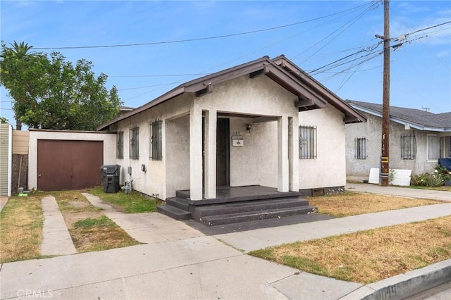 1045 E New York St, Long Beach, CA 90813 - bungalow-style home featuring stucco siding, driveway, and a garage