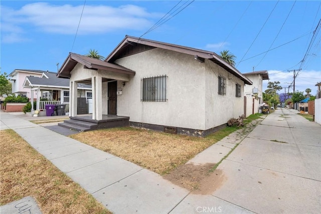1045 E New York St, Long Beach, CA 90813 - bungalow-style home with stucco siding and a front lawn
