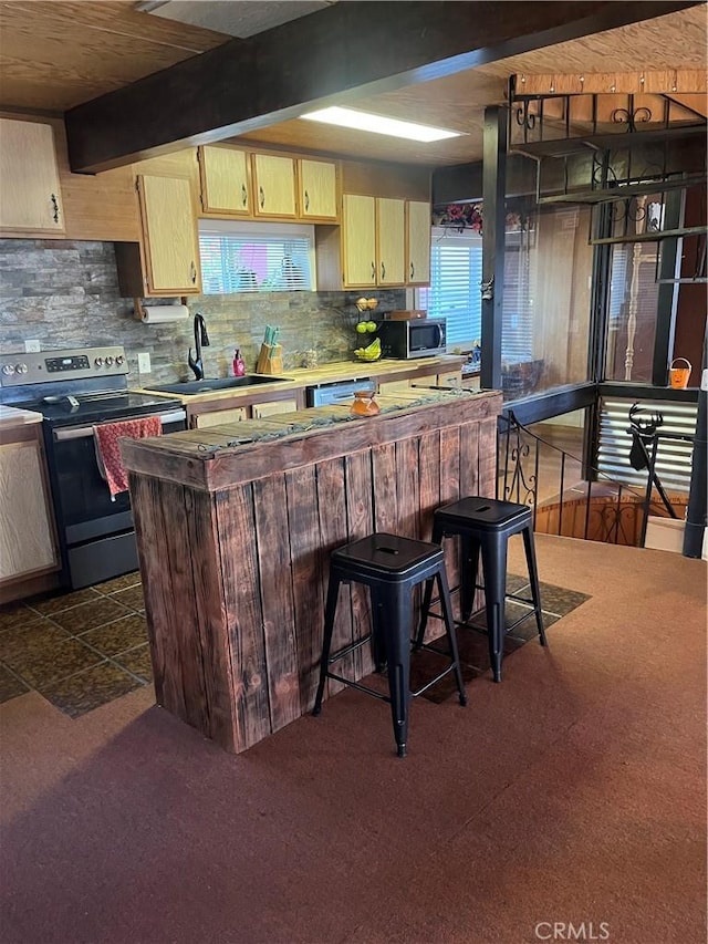 6070 Manzanita Ct, Angelus Oaks, CA 92305 - kitchen with stainless steel appliances, tasteful backsplash, dark carpet, a kitchen bar, and light countertops