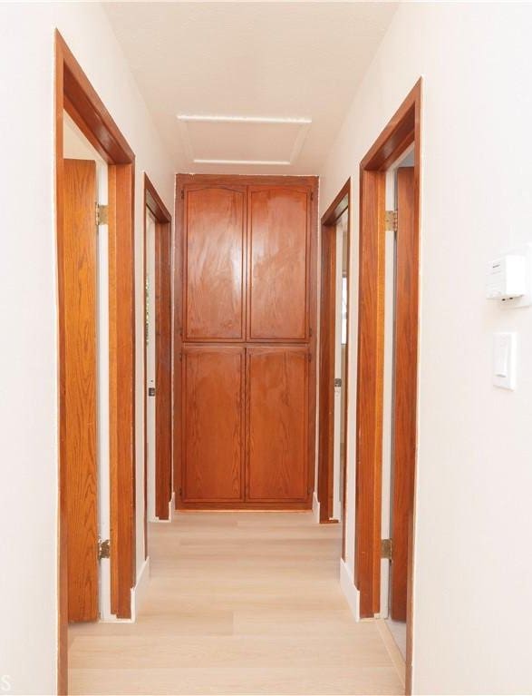 12711 Leroy Ave, Garden Grove, CA 92841 - corridor featuring light wood-style floors and attic access