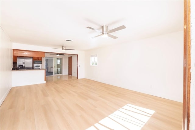 12711 Leroy Ave, Garden Grove, CA 92841 - unfurnished living room with a ceiling fan and light wood finished floors