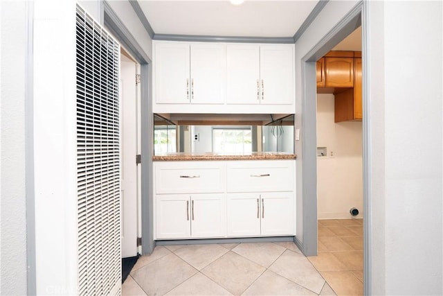 12711 Leroy Ave, Garden Grove, CA 92841 - laundry room with a heating unit, cabinet space, light tile patterned flooring, hookup for a washing machine, and crown molding