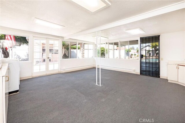 12711 Leroy Ave, Garden Grove, CA 92841 - unfurnished room featuring carpet, plenty of natural light, french doors, and washing machine and clothes dryer