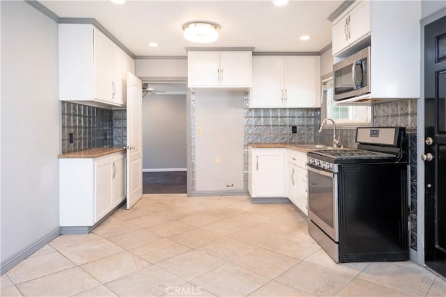 12711 Leroy Ave, Garden Grove, CA 92841 - kitchen featuring appliances with stainless steel finishes, light stone countertops, backsplash, white cabinets, and recessed lighting