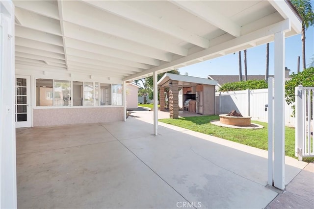 12711 Leroy Ave, Garden Grove, CA 92841 - fenced backyard with a fire pit, a patio, and a storage unit