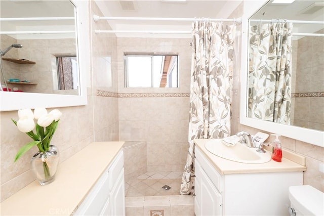 12711 Leroy Ave, Garden Grove, CA 92841 - bathroom featuring vanity, tile walls, a tile shower, and tile patterned floors