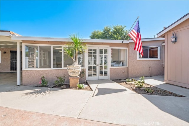 12711 Leroy Ave, Garden Grove, CA 92841 - property entrance with french doors, a patio area, and stucco siding