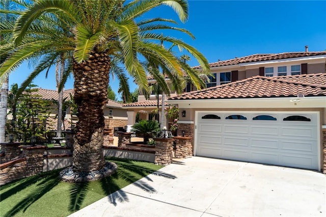2417 Lenai Cir, Corona, CA 92879 - mediterranean / spanish home featuring concrete driveway, a garage, stucco siding, a tiled roof, and stone siding