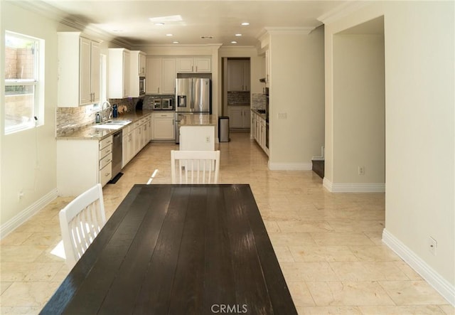 2417 Lenai Cir, Corona, CA 92879 - kitchen featuring appliances with stainless steel finishes, backsplash, a kitchen island, ornamental molding, and recessed lighting