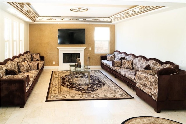 2417 Lenai Cir, Corona, CA 92879 - living room featuring a tray ceiling, a glass covered fireplace, and crown molding