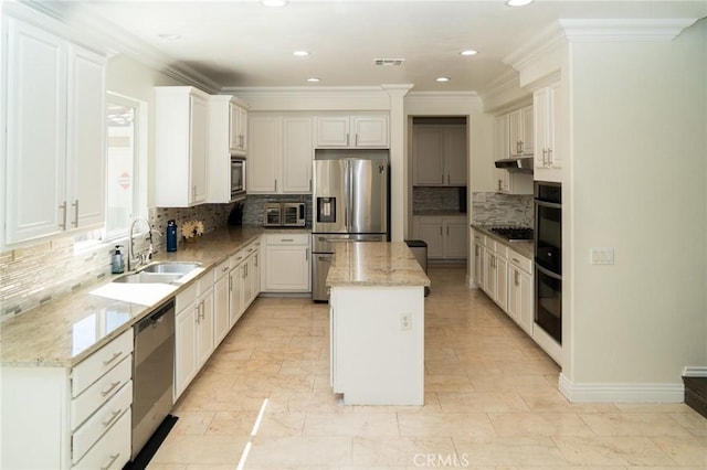 2417 Lenai Cir, Corona, CA 92879 - kitchen with appliances with stainless steel finishes, a center island, backsplash, ornamental molding, and recessed lighting