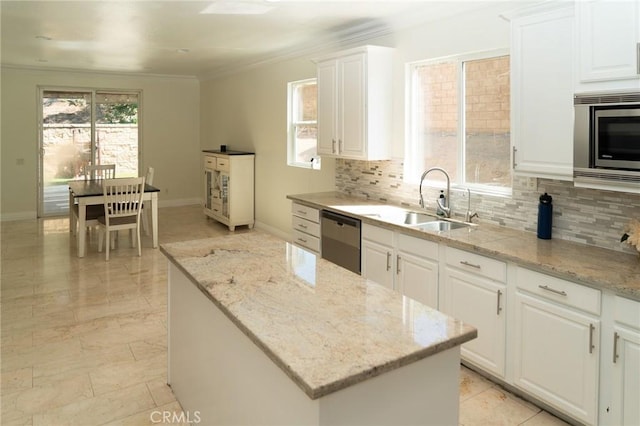 2417 Lenai Cir, Corona, CA 92879 - kitchen with dishwasher, stainless steel microwave, ornamental molding, tasteful backsplash, and white cabinetry