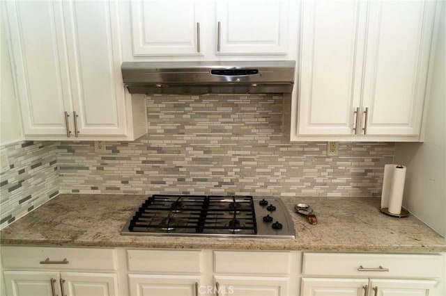 2417 Lenai Cir, Corona, CA 92879 - kitchen with stainless steel gas cooktop, under cabinet range hood, decorative backsplash, white cabinetry, and light stone counters