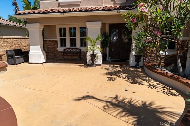 2417 Lenai Cir, Corona, CA 92879 - view of exterior entry featuring stone siding, stucco siding, a patio, and a tiled roof
