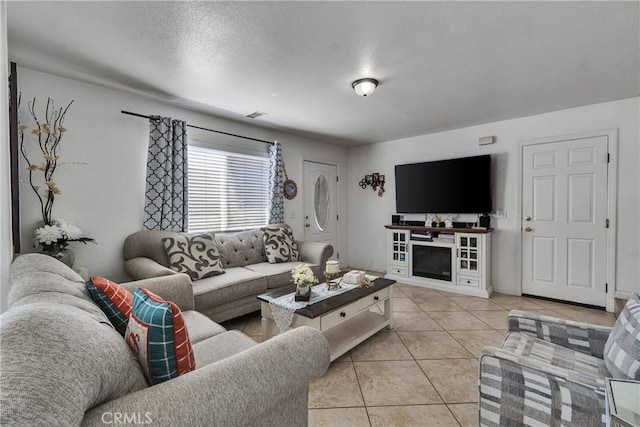 8630 Elba St, Pico Rivera, CA 90660 - living room with light tile patterned flooring and a textured ceiling