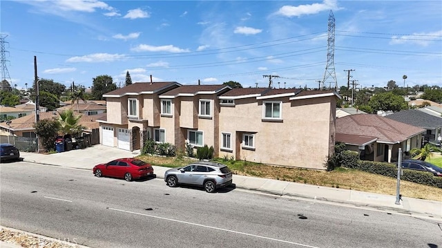8630 Elba St, Pico Rivera, CA 90660 - multi unit property featuring stucco siding, a residential view, a garage, and driveway