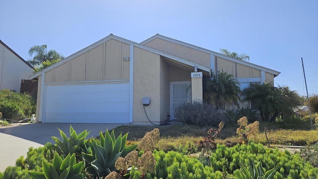 4028 Johnson Dr, Oceanside, CA 92056 - view of front of property featuring an attached garage, driveway, and board and batten siding