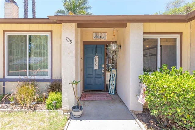 705 Old Bridge Rd, Fallbrook, CA 92028 - view of exterior entry featuring stucco siding and a chimney