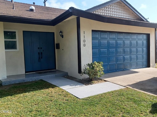1100 Dahlia St, Oxnard, CA 93036 - property entrance with stucco siding, concrete driveway, and a lawn