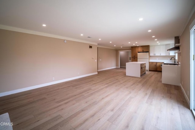 1100 Dahlia St, Oxnard, CA 93036 - unfurnished living room with recessed lighting, crown molding, and light wood-type flooring