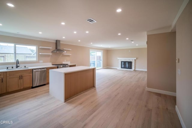 1100 Dahlia St, Oxnard, CA 93036 - kitchen with dishwasher, wall chimney exhaust hood, a center island, ornamental molding, and light wood-type flooring