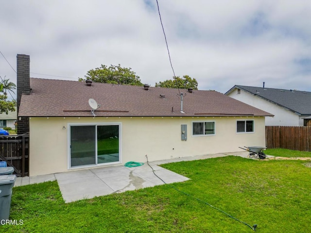 1100 Dahlia St, Oxnard, CA 93036 - back of property featuring stucco siding, a patio area, roof with shingles, and a chimney
