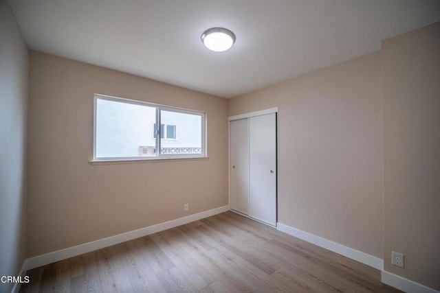 1100 Dahlia St, Oxnard, CA 93036 - unfurnished bedroom featuring wood finished floors and a closet