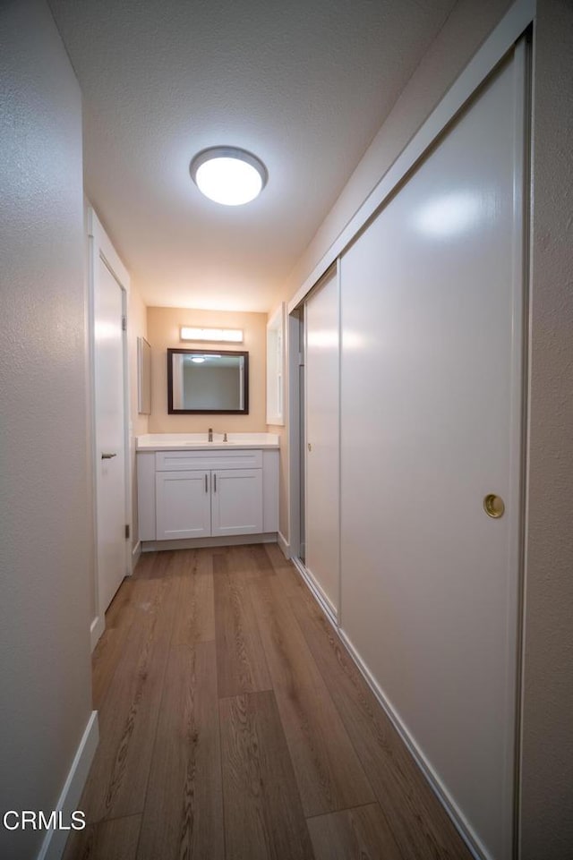 1100 Dahlia St, Oxnard, CA 93036 - corridor featuring light wood-style floors and baseboards