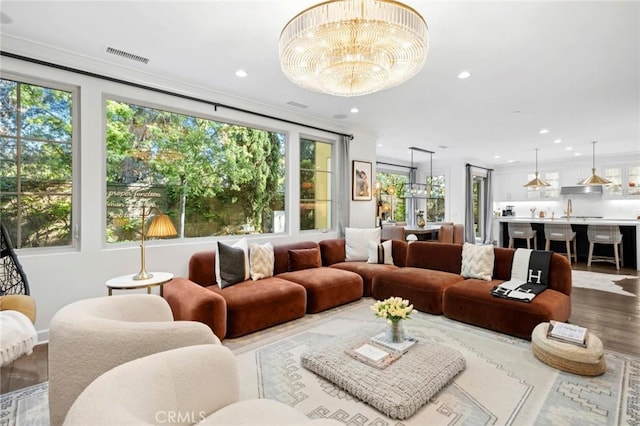 24 Tesoro, Irvine, CA 92618 - living area featuring plenty of natural light, a chandelier, wood finished floors, recessed lighting, and crown molding