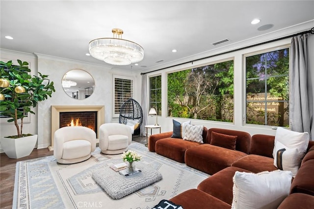 24 Tesoro, Irvine, CA 92618 - living area with ornamental molding, recessed lighting, a high end fireplace, wood finished floors, and a chandelier