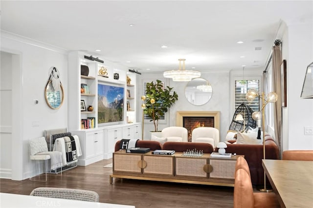 24 Tesoro, Irvine, CA 92618 - living area featuring dark wood finished floors, ornamental molding, a warm lit fireplace, a chandelier, and recessed lighting