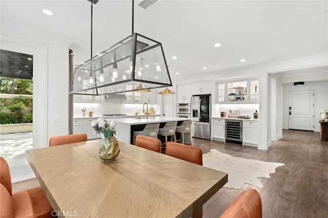 24 Tesoro, Irvine, CA 92618 - dining area with ornamental molding, beverage cooler, recessed lighting, wet bar, and wood finished floors
