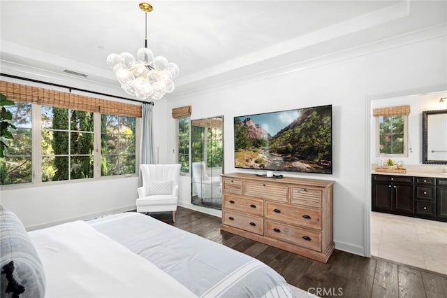 24 Tesoro, Irvine, CA 92618 - bedroom with a chandelier, a raised ceiling, dark wood-style flooring, and connected bathroom