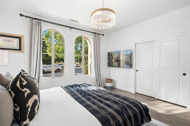 24 Tesoro, Irvine, CA 92618 - bedroom featuring wood finished floors, a chandelier, and a closet