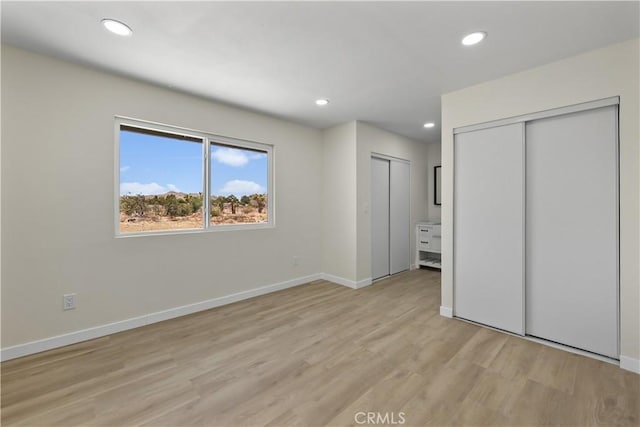 40635 159th St E, Lancaster, CA 93535 - unfurnished bedroom with light wood finished floors, multiple closets, and recessed lighting