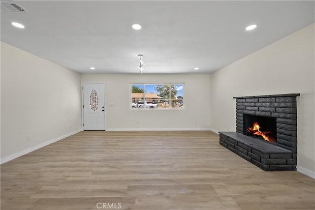 40635 159th St E, Lancaster, CA 93535 - unfurnished living room featuring a fireplace, light wood-style flooring, and recessed lighting