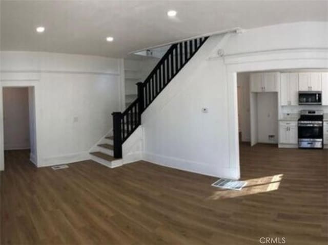 2626 5th St, Riverside, CA 92507 - unfurnished living room with dark wood finished floors, stairs, and recessed lighting