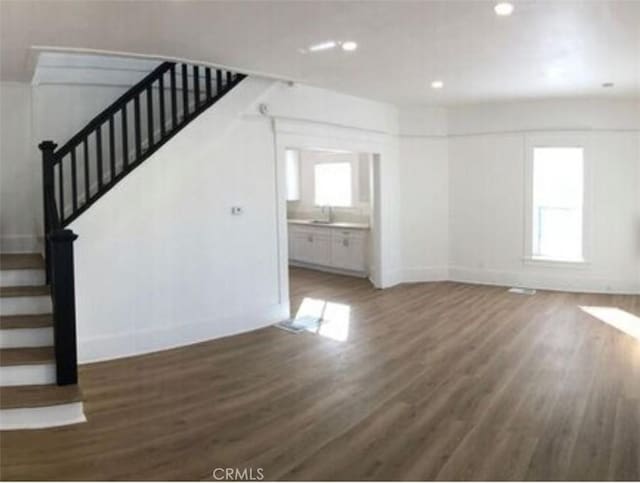 2626 5th St, Riverside, CA 92507 - unfurnished living room featuring wood finished floors, stairs, and recessed lighting