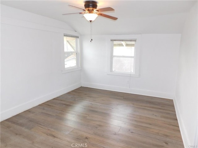 2626 5th St, Riverside, CA 92507 - empty room featuring healthy amount of natural light, lofted ceiling, a ceiling fan, and wood finished floors