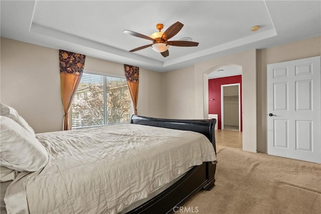 29513 Blake Way, Canyon Country, CA 91387 - bedroom with a raised ceiling, arched walkways, light colored carpet, and a ceiling fan