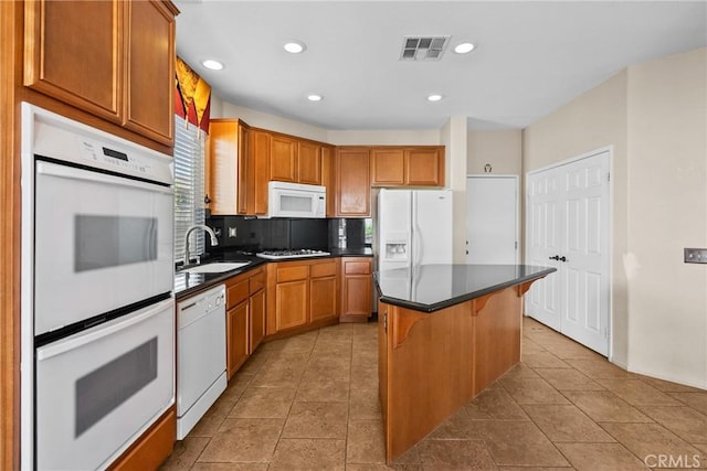 29513 Blake Way, Canyon Country, CA 91387 - kitchen featuring white appliances, dark countertops, backsplash, a center island, and recessed lighting