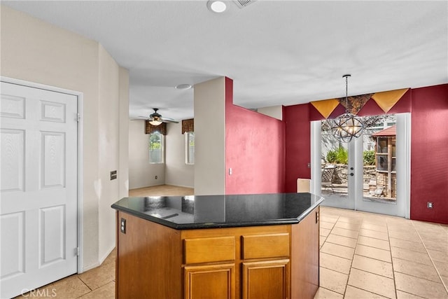 29513 Blake Way, Canyon Country, CA 91387 - kitchen featuring dark countertops, light tile patterned flooring, a center island, pendant lighting, and a chandelier