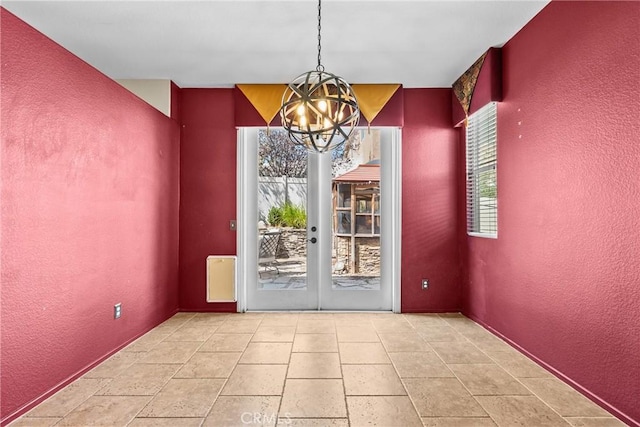 29513 Blake Way, Canyon Country, CA 91387 - unfurnished dining area featuring a chandelier, a textured wall, and french doors