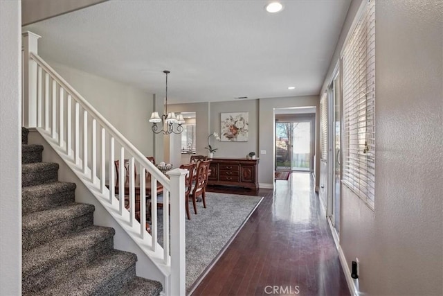 30336 Barcelona Rd, Castaic, CA 91384 - entryway with stairway, dark wood finished floors, a chandelier, and recessed lighting